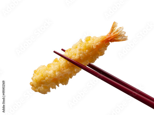 Shrimp tempura lifted with chopsticks against a white background.