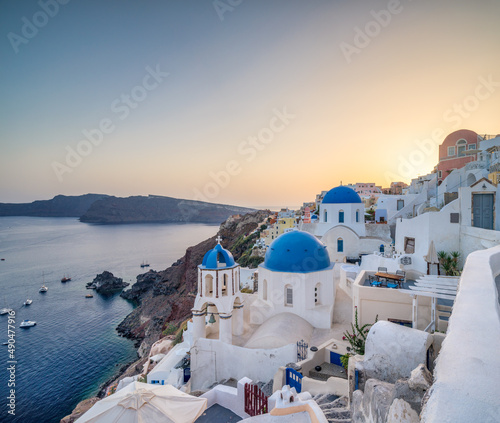 Sunset view of the blue dome church in Oia, Santorini, Greece