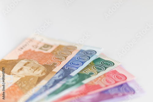 Multiple denomination bank notes on isolated white background