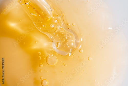 Vitamin C serum liquid texture with dropper, macro shot.