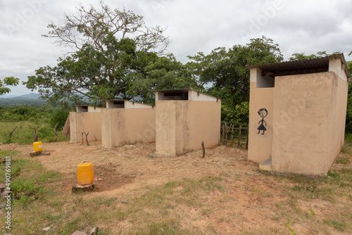 Latrines for primary school students, with buckets of water outside