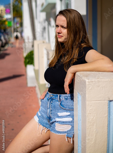Young woman posing for the camera in the Art Deco District of South Beach Miami