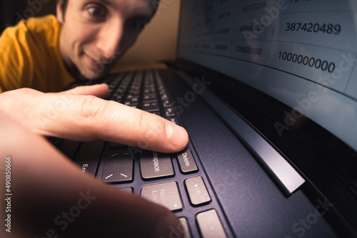 Man pressing delete button on keyboard