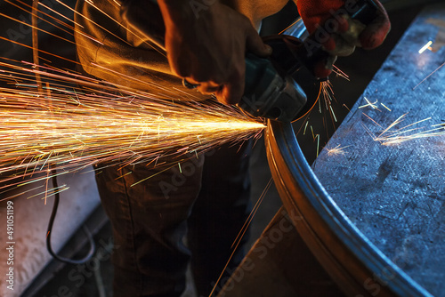 Flex metalworking. Worker cuts metal at a construction site