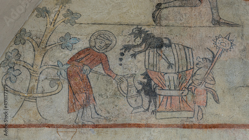 ancient fresco depicting a monk pouring beer from a barrel
