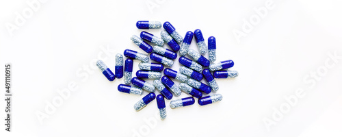 Selective focus, group of blue medical pills isolated on white background.Health and medicine concept
