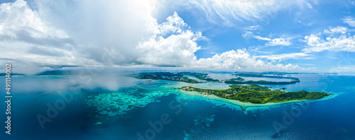 Aerial panorama of tropical islands clouds and rain showers