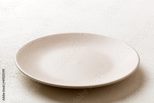 Perspective view of empty light plate on cement background. Empty space for your design