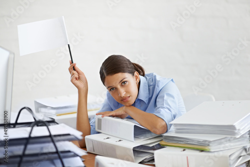 I surrender. Shot of a young businesswoman holding up a white flag and looking defeated.