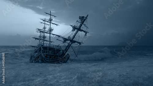 An old shipwreck (old sailing ship) abandoned stand on beach