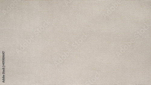 horizontal textile background - beige corduroy jacket close up