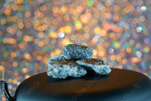 Granites are coarsely crystalline plutonic rocks rich in quartz and feldspar, but also contain dark minerals, mainly mica, photographed in the studio