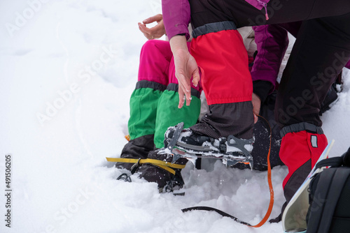 Mountain hiking gear being put on by a hiker