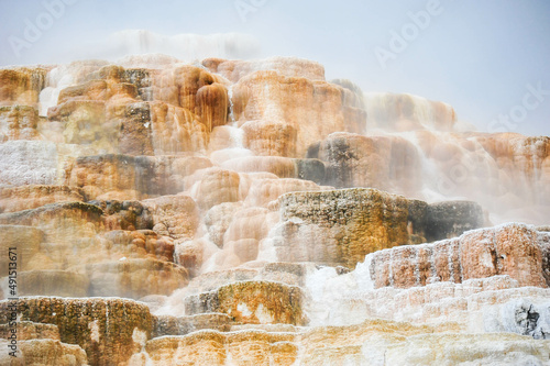 Mist from hot water drops over limestone creating abstract staircase of color at Mammoth in Yellowstone National Park