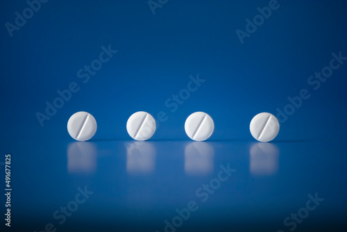 Concept of pills Men Women Kids Health on blue horizontal plane background Hight quality Photo. Fake medicine - placebo is a sham substance or treatment which is designed to have no therapeutic value