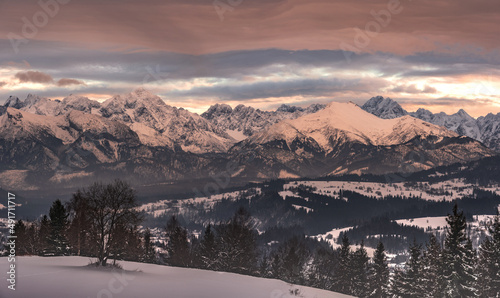 panorama of the snowy Tatra Mountains against the backdrop of the setting sun