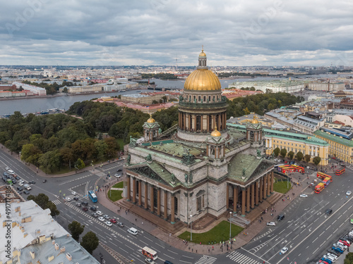 Aerial photo of Saint Isaacs Cathedral in Saint Petersburg. Large orthodox church with golden dome and colonnade. Travel destination. Cloudy sky. Vacation concept.