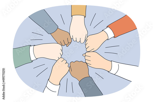 Collaboration teamwork and unity concept. Top view of diverse multi racial group of people pulling fists together in circle meaning togetherness and tolerance vector illustration 
