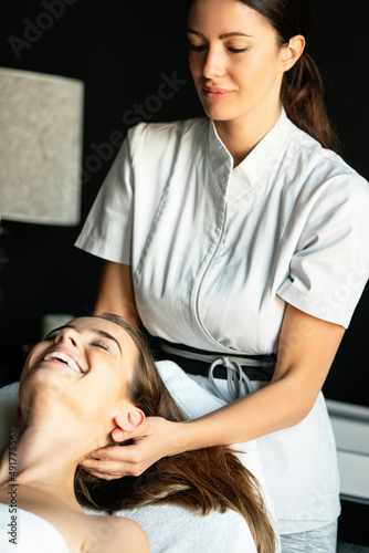 Attractive young healthy woman in spa salon having massage