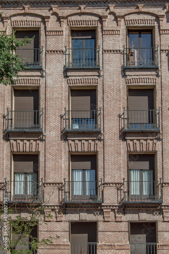 brick building facade with balconies in vertical