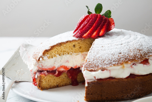 Close up of homemade Victoria sponge cake showing the filling