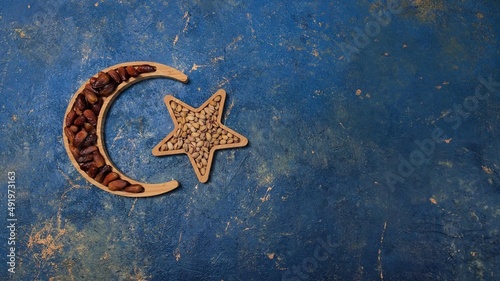 Ramadan, a crescent moon with a star and dates. A symbol of Islam. Background with copy space for place a text, message for advertisement, and promote your brand and product