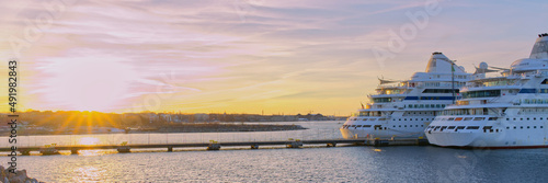 2 Cruises ships waiting in Tallinn harbour for a return sail date ships. sunset time in harbour. luxury liners at wonderful evening time. Multi-colored sky. close up