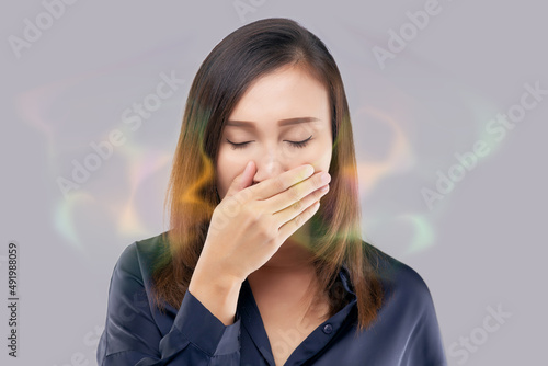 Asian female in blue wear have bad breath. Halitosis