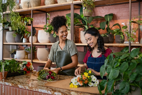 Two multiethnic women working in florist shop together