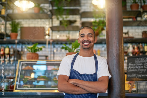 Customers always stop by for some quality service. Portrait of a young entrepreneur standing in his business.