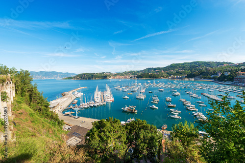 Panoramic view of the port of Lerici with many recreational boats moored and the village of San Terenzo. Tourist resorts on the coast of Gulf of La Spezia, Liguria, Mediterranean sea, Italy, Europe.