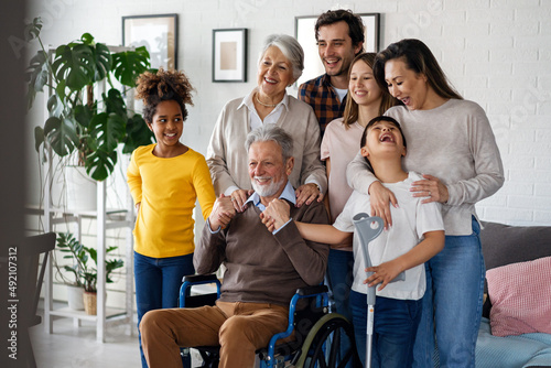 Multi generation, multiethnic family at home together, grandfather with disability