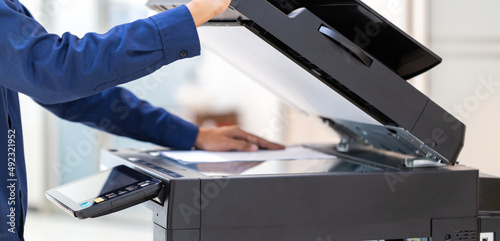 Businessman press button on panel of printer photocopier network , Working on photocopies in the office concept , printer is office worker tool equipment for scanning and copy paper.