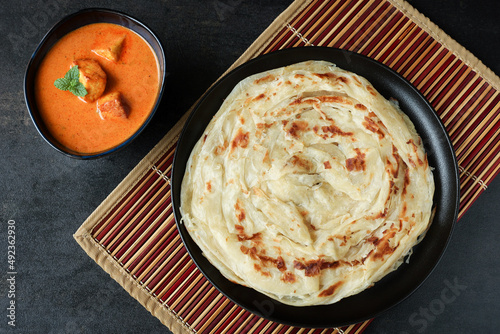 Kerala parathas / porotta / roti / parotta / barotta/ naan layered flatbread made from maida or whole wheat flour. Eat with spicy Asian chicken or beef or egg curry gravy. breakfast dish. Indian food.