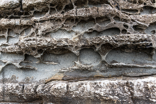 texture of porous stones on the beach, nature, natural phenomena, brown gray stones