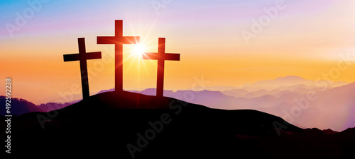 Easter background banner panorama religious greeting card Crucifixion and Resurrection. Three crosses of Golgotha by sunset...