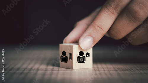 Hybrid workplace schedule, Gig economy, Freelance, Online business network communication, teamwork, home office concept. Hand hold wooden cube icon of gig economy, copy space for background or text.