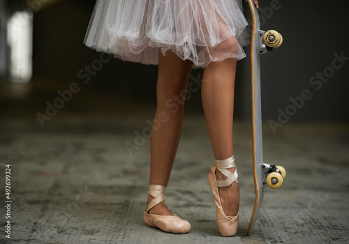 Grace on wheels. A cropped image of a woman in ballet slippers on a skateboard.
