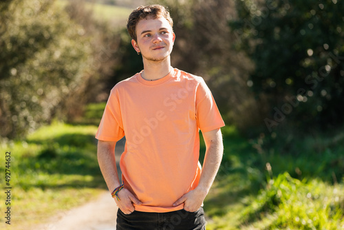 trans man strolls happily along a trail