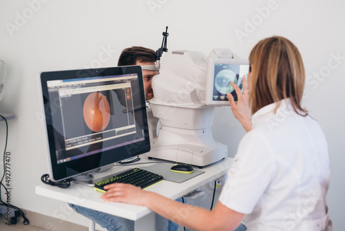 man patient has eye examination. digital retina scanner