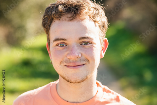 portrait of handsome young transgender teenager man model posing happy