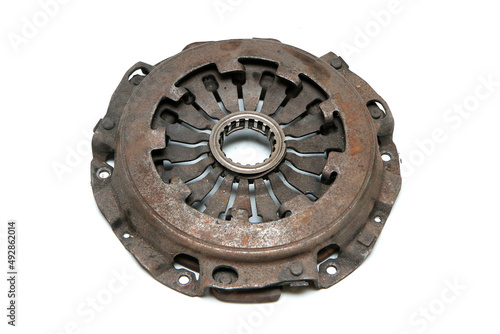 The old rusty used clutch from the car engine isolated in a white background. Has to be changed for new one. 
