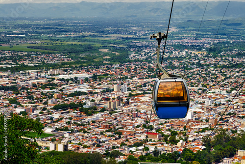 Aerial lift cabin descending from San Bernardo hill in Salta, Argentina