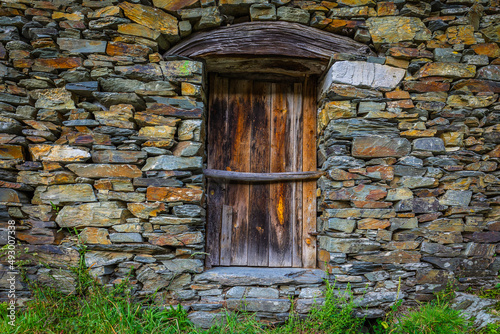 Wooden old door in a schist house in the touristic village of Piodao - Portugal. Schist villages - Portugal