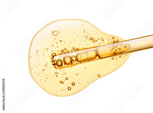Liquid yellow vitamine c or retinol transparent gel or serum with dropper pipette on white isolated background