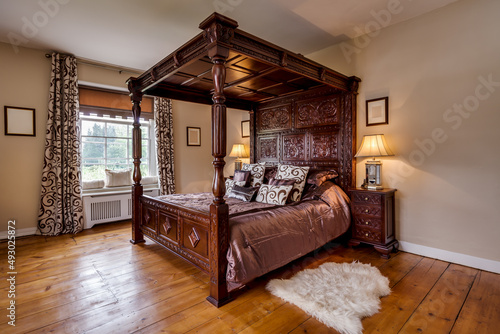 victorian rectory bedroom with ornate carved four poster bed