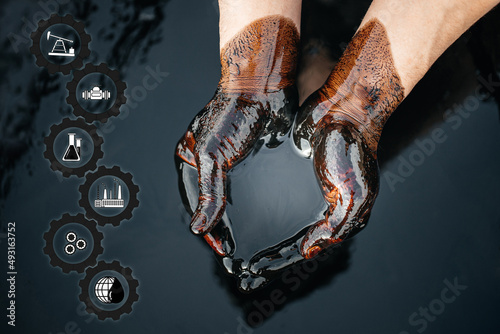 Crude oil in the hands due to a fuel oil leak. process of processing petroleum products. Cupped hands with fuel oil. the crisis of the oil and gas industry. Economic downturn.