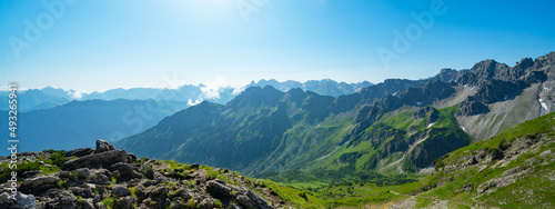Kleinwalsertal alps mountains landscape panorama background - Mountain panorama in summer with blue sky in Austria..