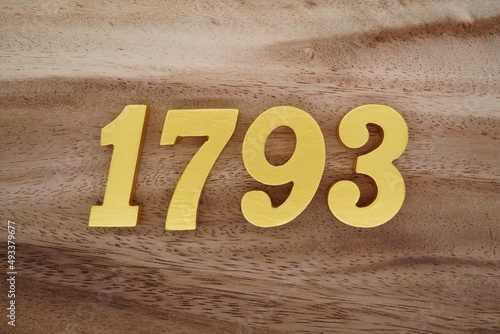 Golden Arabic numerals on a real brown and white wooden floor number 1793