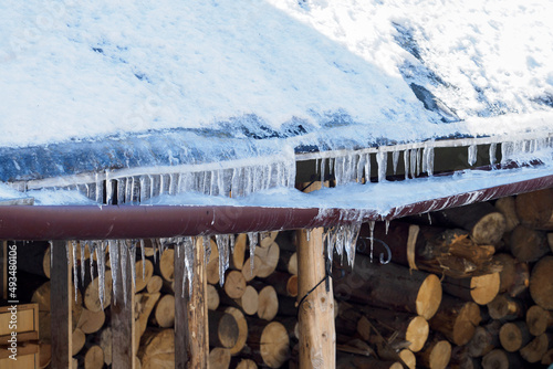 Eaves weighed down with ice in winter.